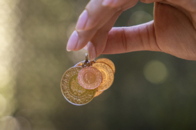 Young woman holding Turkish Gold coins in hand