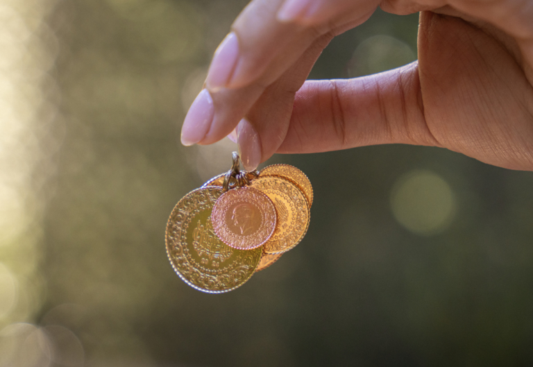 Young woman holding Turkish Gold coins in hand
